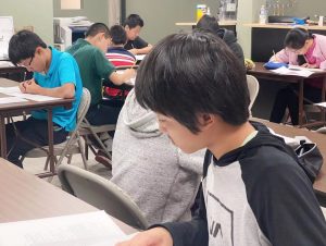 Students take the AMC 10A+12A exam at Areteem Headquarters